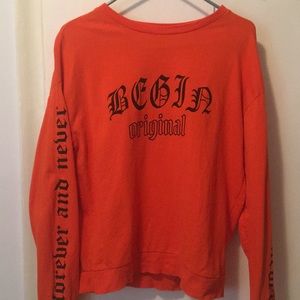 orange H&M sweatshirt.